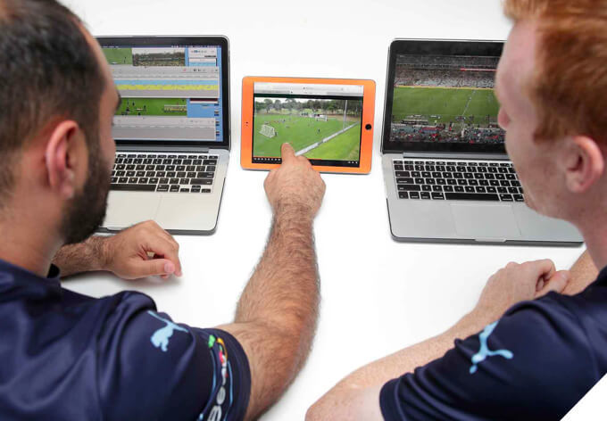 Two analysts using Sportscode on laptops and an iPad