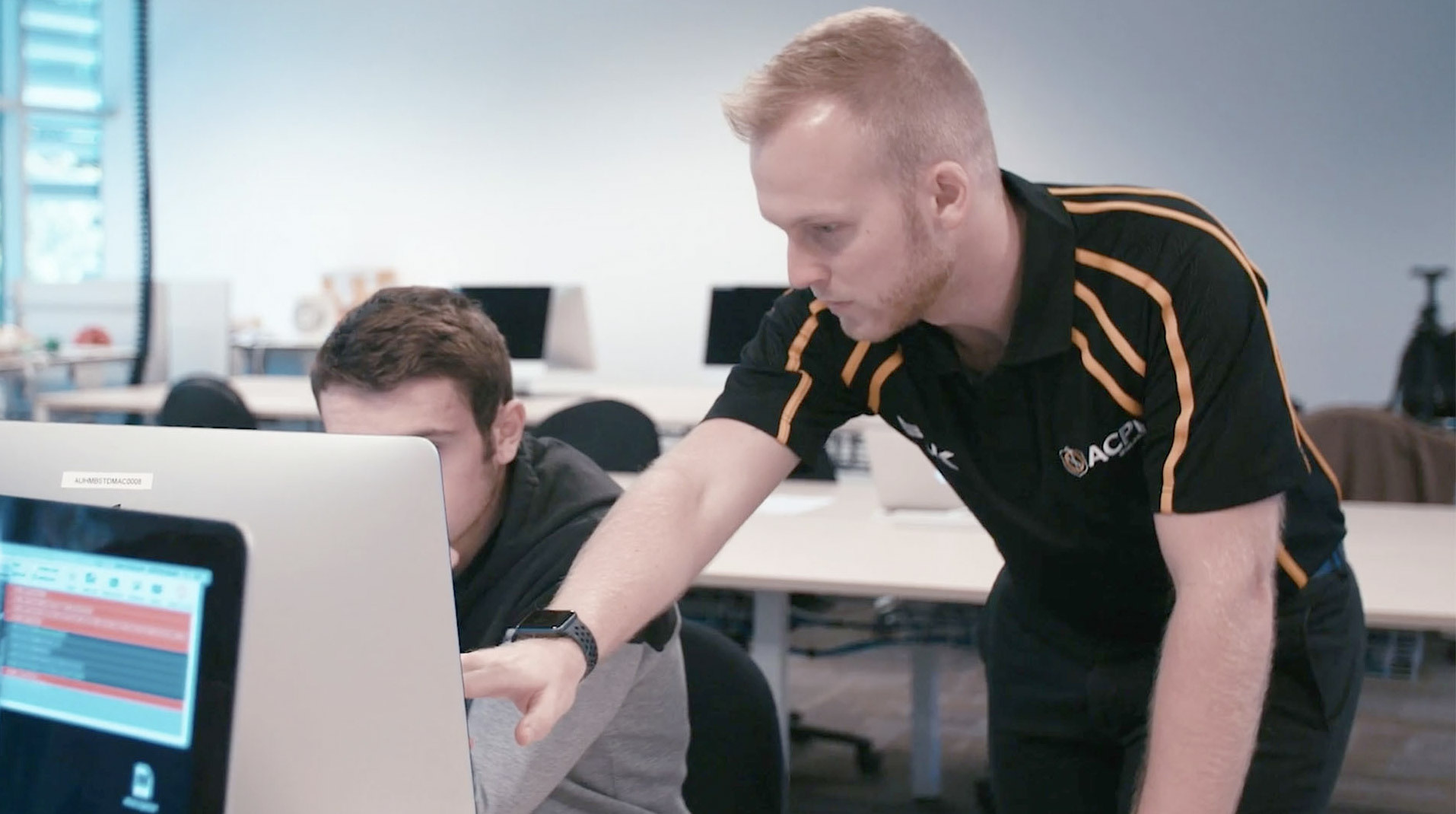 Photo of Jay Ellis giving one-on-one instruction to a student