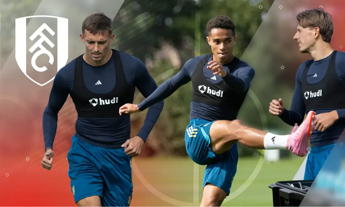 Three Fulham FC players wearing black Hudl-branded GPS tracking vests during an outdoor training session.